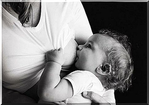 Baby breastfed by his mother