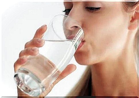 Woman hydrating herself by drinking water