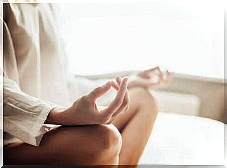 Woman meditating in bed