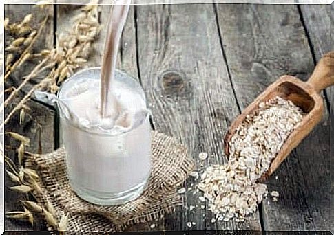 Glass of milk next to oats